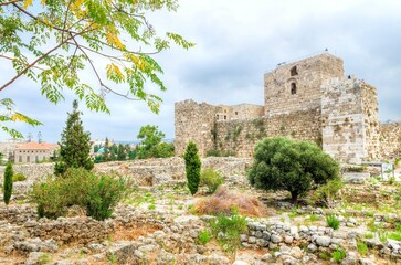 Fototapeta premium The crusaders' castle in the historic city of Byblos in Lebanon. A view of the western walls and a path leading to the east of the ancient site discovered in the area.