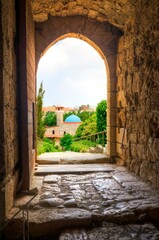View of the mosque in the historic city of Byblos, Lebanon through the door gate of the crusader castle, a landmark of Jbeil.