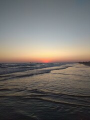 Fototapeta premium Sunset at the beach with silver waves