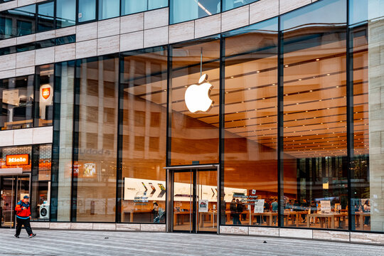 21 July 2022, Dusseldorf, Germany: Apple logo at the entrance to the store. Buying modern iphones and electronics. Phones and macintosh at the display of the shop