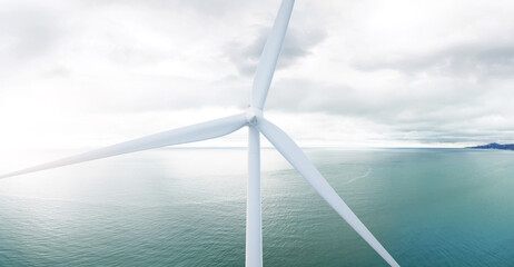 Wind turbine generating electricity. 3D illustration. Wind turbines: 3d-model. Background: photo-panorama. The sea is covered with ice.