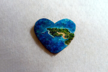 Small island in the shape of a heart. Love for travel and adventure. Romantic valentine's day gift. Islet-heart in the blue sea