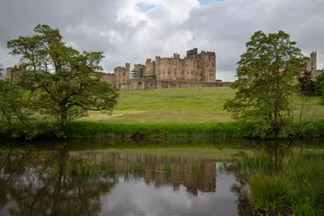 Foto op Canvas Alnwick Castle reflected in the water of the River Aln. Northumberland, UK © Christopher Keeley