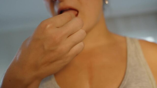 The girl tries dogwood and winces from the acid. close-up. in motion. slow motion