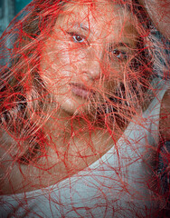 Beautiful girl behind of transparent veil