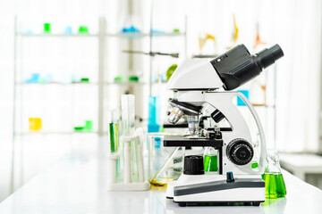 Colorful rows of laboratory or classroom test tubes and microscope with metal lens, Science and education. Scientific experiment, Researcher, Concept of medical or science laboratory,