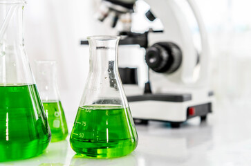 Colorful rows of laboratory or classroom test tubes and microscope with metal lens, Science and education. Scientific experiment, Researcher, Concept of medical or science laboratory,