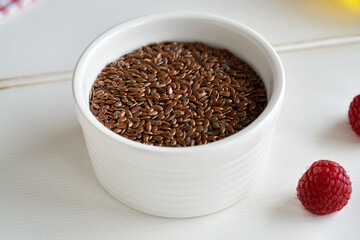 Flax or linseeds in a white bowl on a table