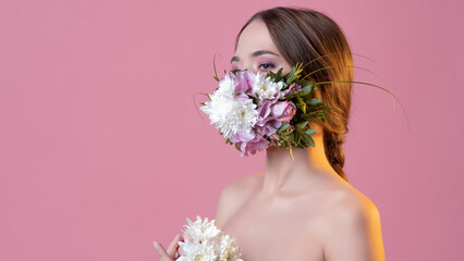 Keep your distance and use protection in the spring, seasonal exacerbation of viral infections and allergies. Young woman in floral face mask, portrait in studio on pink background