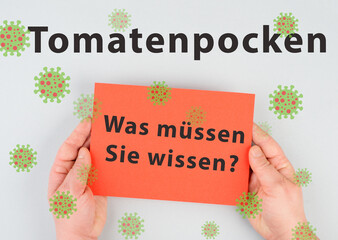 The words tomato pox, what you need to know, are standing in german language on a paper, outbreak...