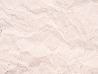 Сrumpled paper texture as an abstract background with warm tint