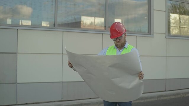 on a large construction site, a very angry engineer examines a blueprint