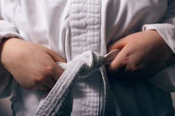 Boy in a kimono for karate or taekwondo classes closeup