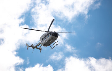 Helicopter close-up against the sky. Rescue helicopter flies in the sky with clouds.