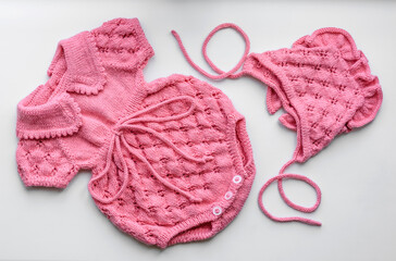 Beautiful baby knitted clothes and a toy for a newborn baby