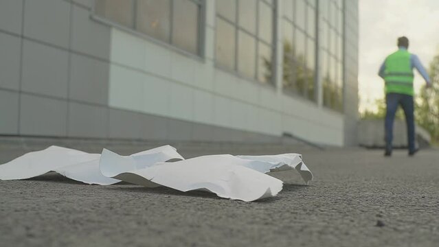 The torn blueprint lies on the ground and the engineer left it away.