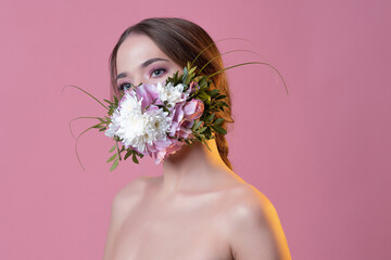 Young beautiful woman in a flower face mask, spring and allergy, concept. Portrait in the studio on...
