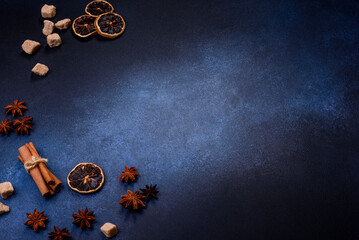 A piece of fresh delicious cake with nuts and chocolate on a black plate against a dark blue background
