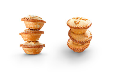 A collection of Christmas mince pies staked, piled up isolated against a flat background.