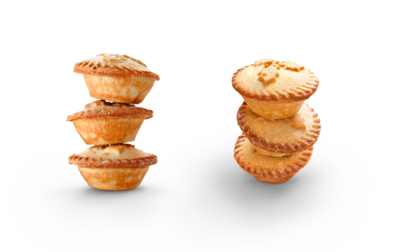 A collection of Christmas mince pies staked, piled up isolated against a flat background.