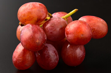 A bunch of Red Grapes on a Black background