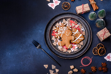 Christmas decorations and gingerbreads on a dark concrete table. Preparing and decorating the house for holiday