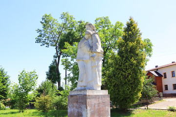 Fototapeta na wymiar White monument with two women in Kosovo, Ukraine