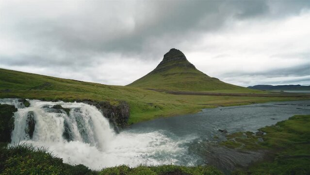 Timelapse of the clouds moving behing Kirkjufell in Iceland. The clouds move fast but the water moves in regulair speed. All insects, birds, cars etc. manually removed. 4k.