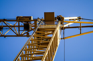yellow crane blue sky closeup