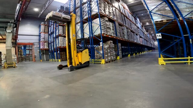 Modern forklift in a large warehouse. Forklift with cargo in the warehouse. industrial interior