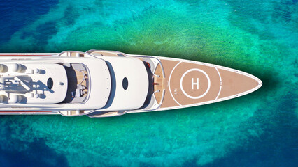 Aerial drone top down ultra wide photo of luxury yacht anchored in tropical exotic island bay with...