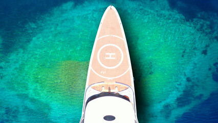 Aerial drone top down ultra wide photo of luxury yacht anchored in tropical exotic island bay with...