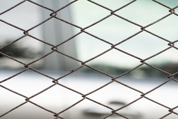 Parking lot of cars behind a metal fence © alexbush