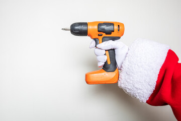 Santa's hands using an orange colored drill