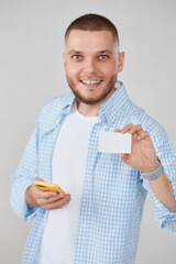 handsome man with smartphone and credit card