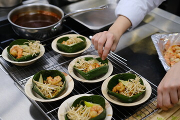 A thai chef cooking a pad thai during a masterclass. Paris, France.