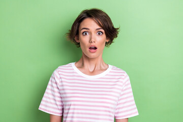 Photo of impressed bob hairdo millennial lady wear white striped t-shirt isolated on green color...