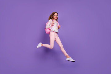 Fototapeta na wymiar Full length profile photo of charming excited person jumping run rush isolated on violet color background