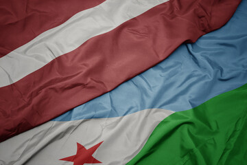 waving colorful flag of djibouti and national flag of latvia.