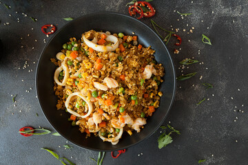 spicy rice with vegetables and squid rings, rice dish with seafood of Asian cuisine
