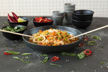 spicy rice with vegetables and squid rings, rice dish with seafood of Asian cuisine