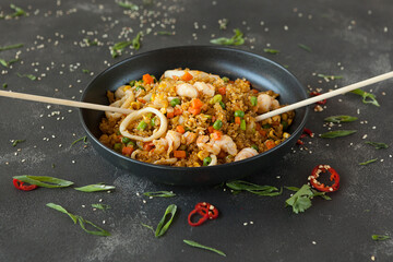 spicy rice with vegetables and squid rings, rice dish with seafood of Asian cuisine