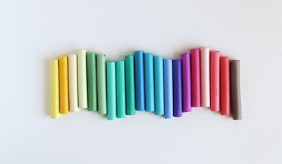 Multicolored soft pastel on a white background. Art materials, Top view
