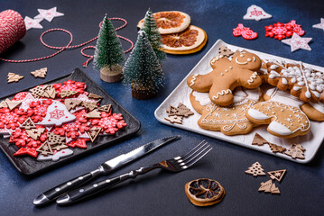 Christmas decorations and gingerbreads on a dark concrete table. Getting ready to celebration
