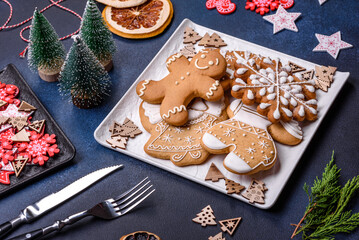 Christmas decorations and gingerbreads on a dark concrete table. Getting ready to celebration