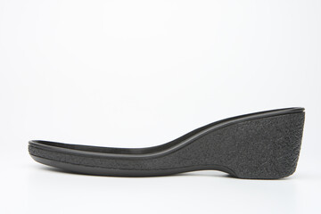Rubber outsole for shoes. Sole of womans shoes close-up. Concept of production of footwear and wardrobe items from polypropylene. Rubber outsole side view. Basis for womans shoes.