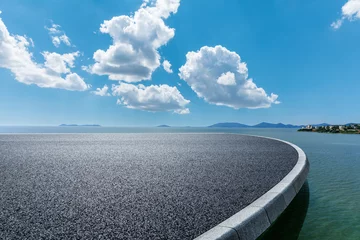  Asphalt road and river with mountain nature landscape under blue sky © ABCDstock