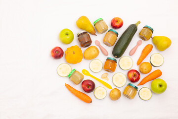 Layout of Puree for baby food with vegetables and fruits. Selective focus. nutrition. The first complementary feeding of the child. A happy child. A well-fed child. Copy space.