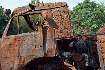 Broken and burned military truck brought to the city park