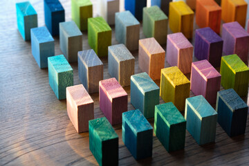 Spectrum of colorful wooden blocks aligned on a rustic old wood table. Japanese Color set. ...